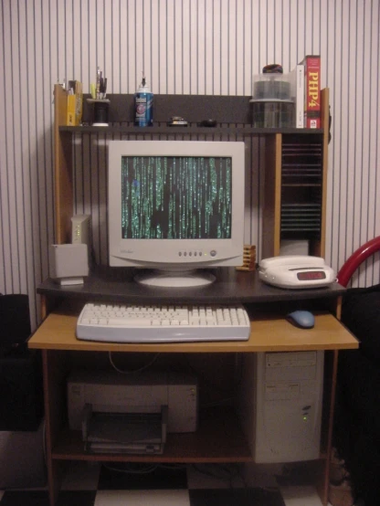 a computer desk with a large monitor and keyboard
