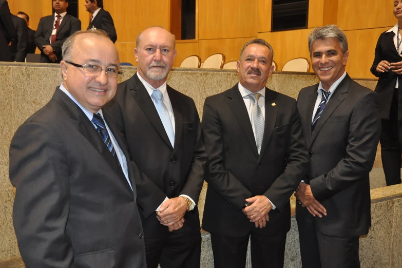 a group of men dressed in business suits posing together