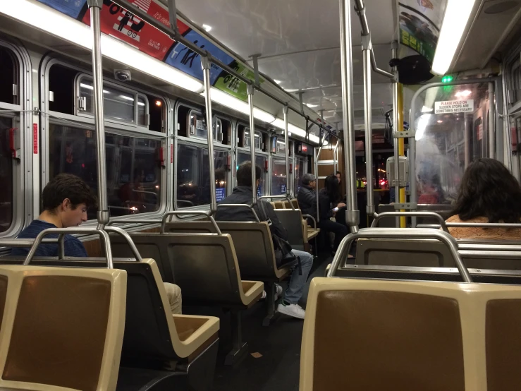 people sit on and are inside of a subway car