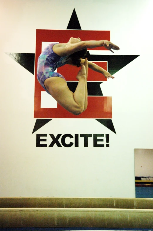 a woman in a blue swimming suit doing an acrobatic move