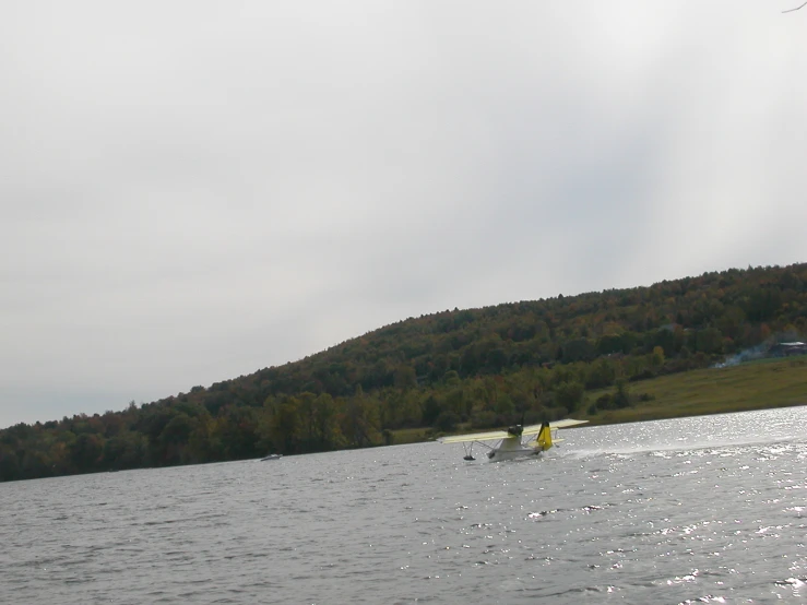 two people on a kayak with a person standing in the water