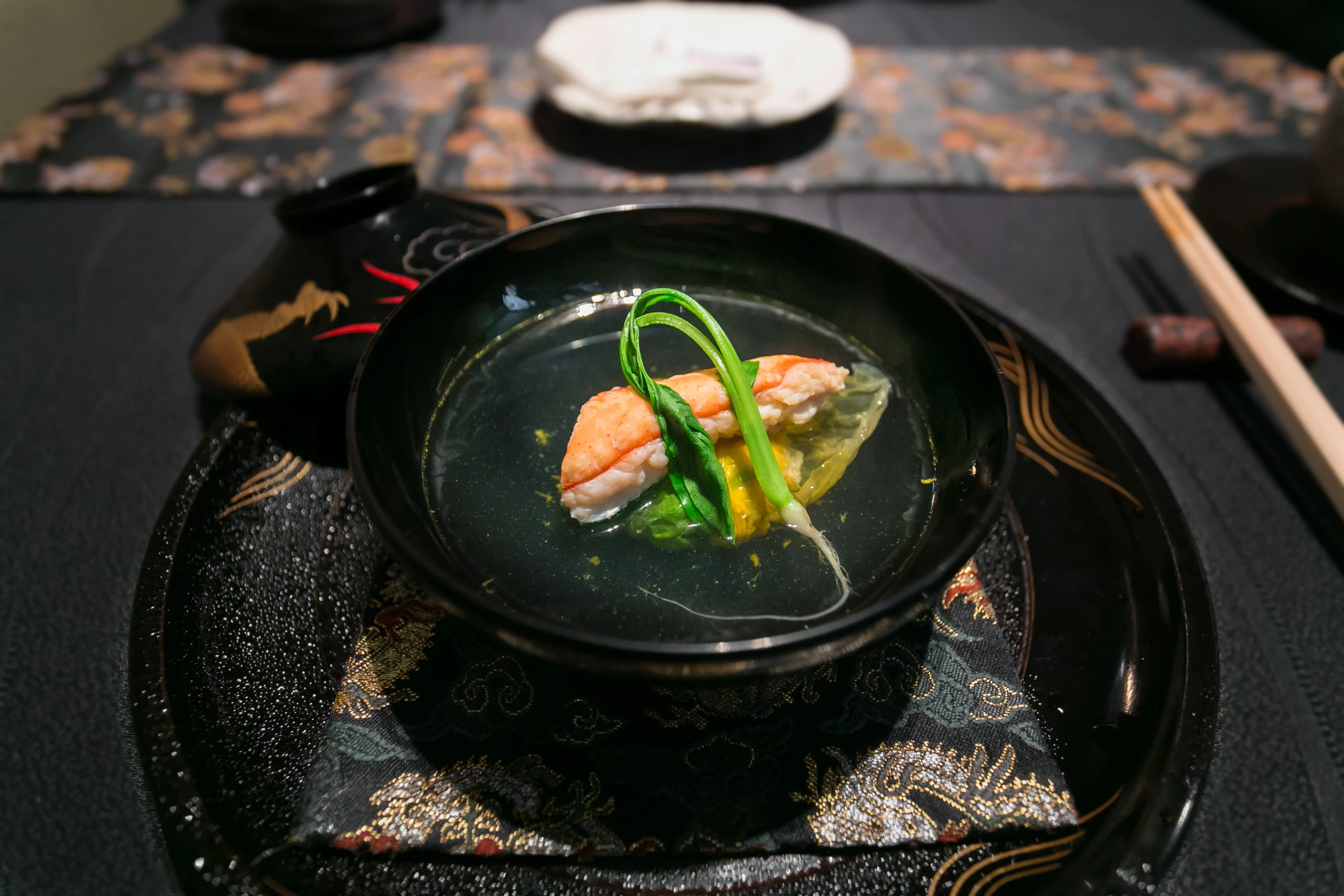 a plate with some sushi and chopsticks on it