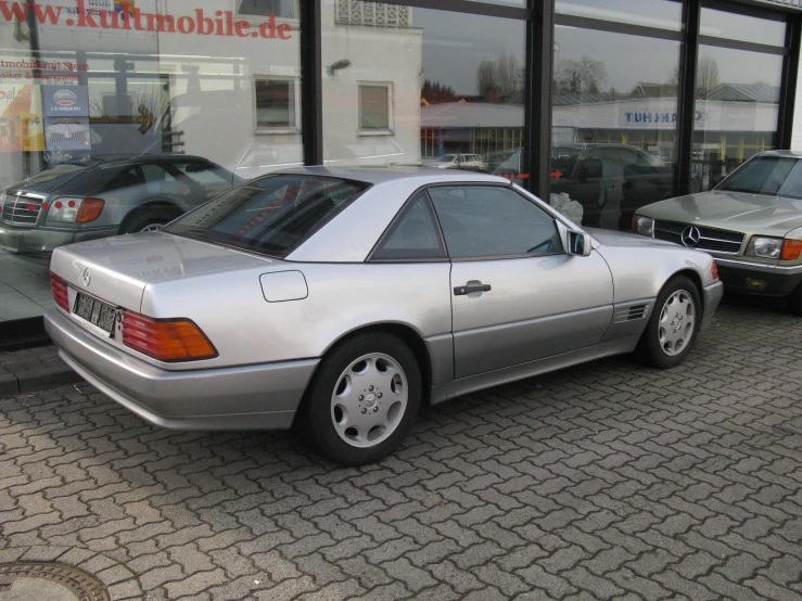 the front view of a car in front of a store