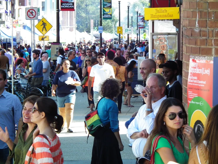 there are people walking down the busy city street