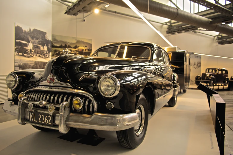 an old model car is in the museum with other vehicles on display