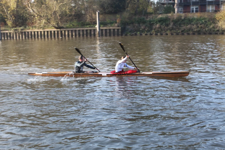 two people on their backs are in the middle of the water