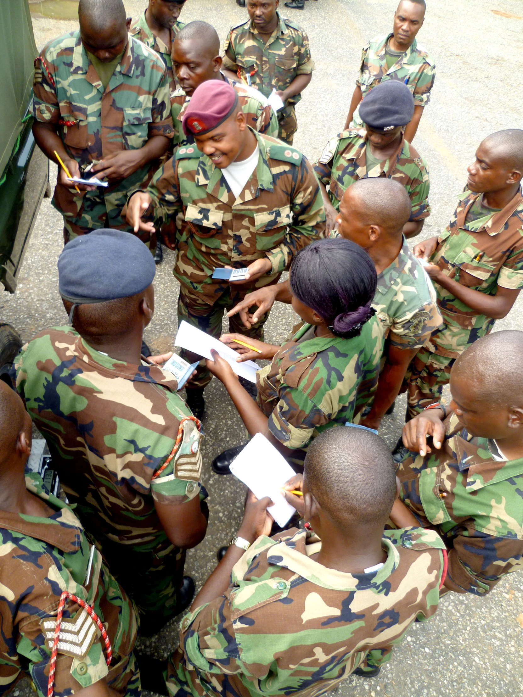 a group of people in uniforms gathered around one another