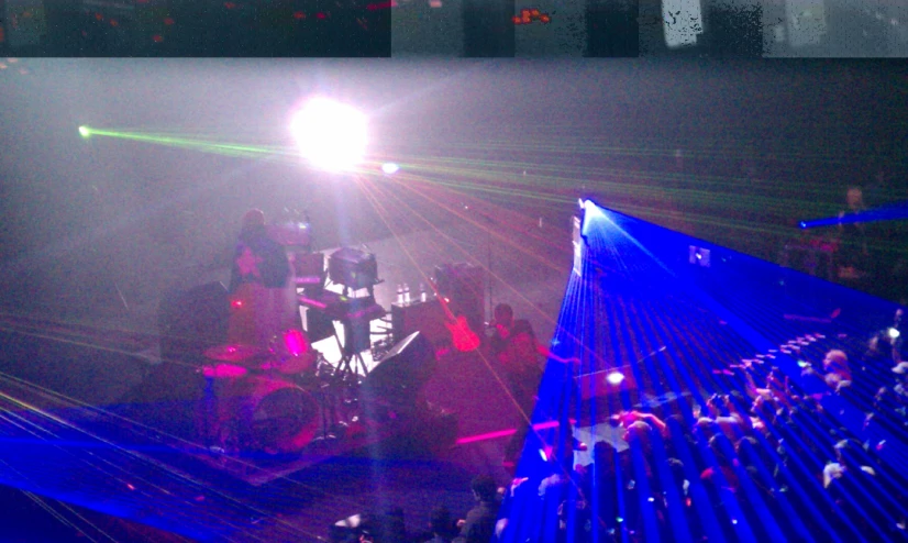 a group of people on stage are watching a show