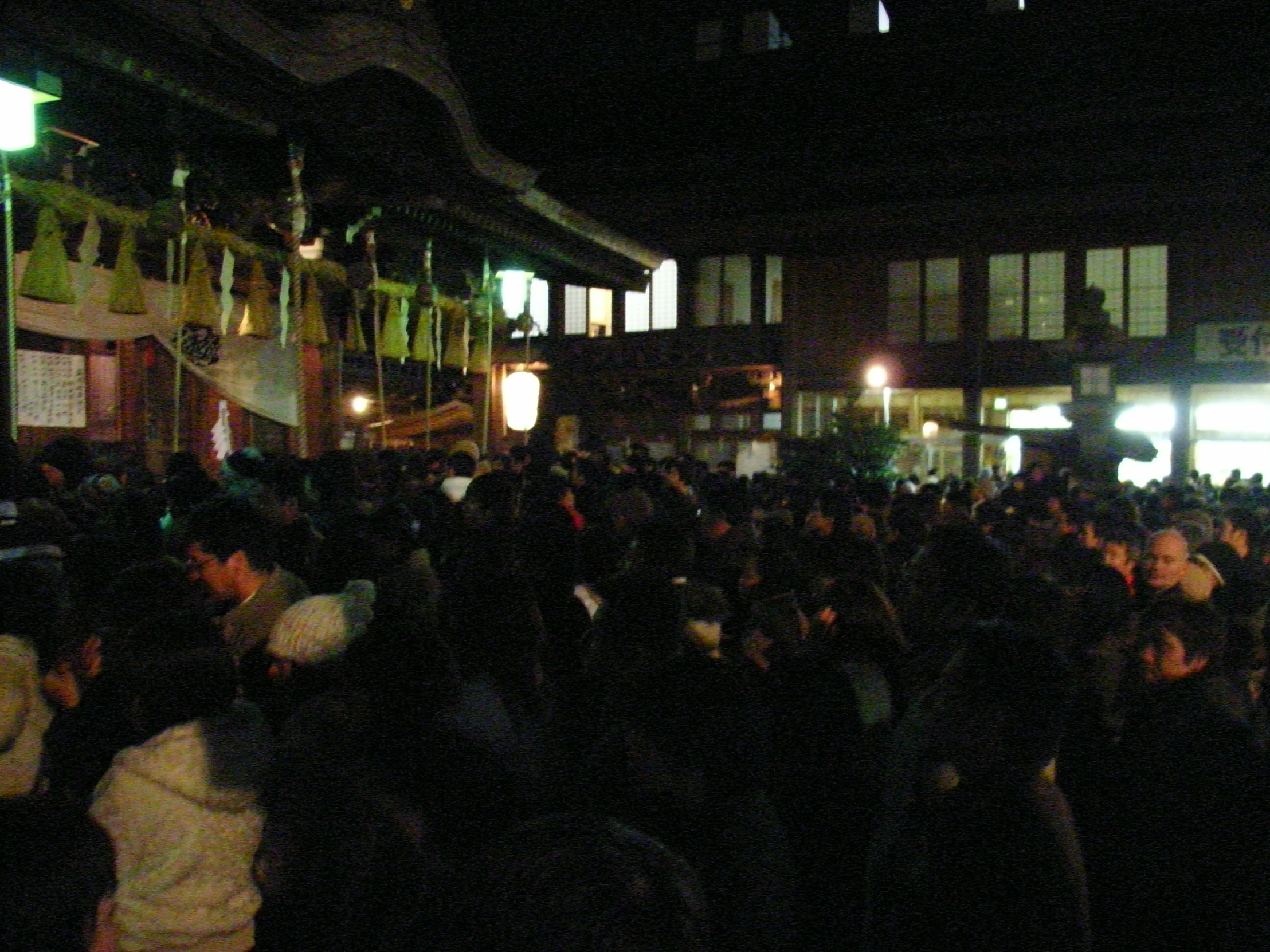 a crowd of people standing around each other on a street