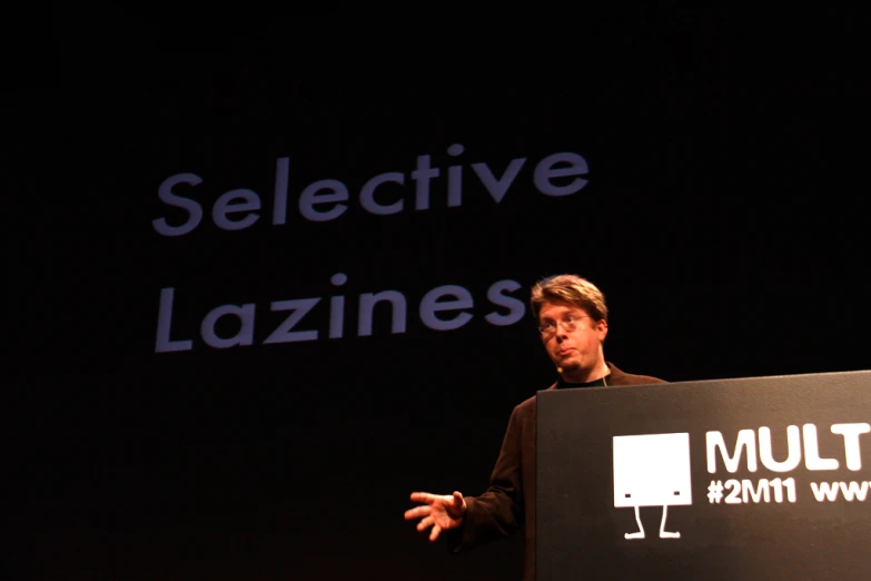 a man standing behind a large sign with the words multi