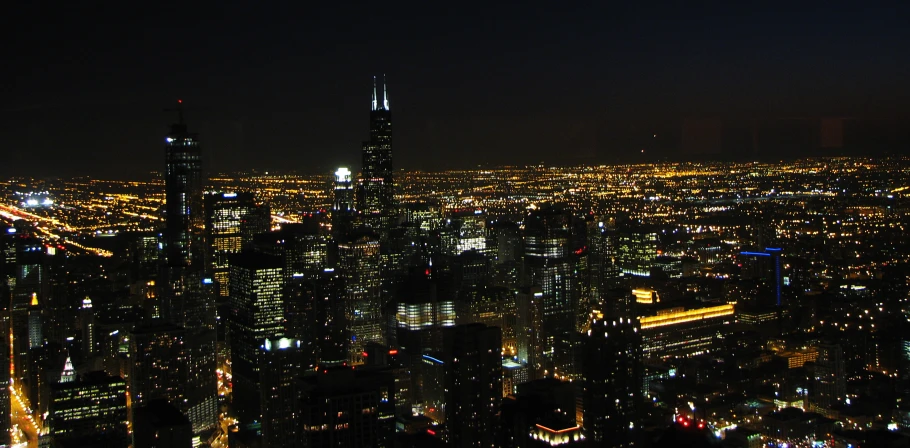 the night skyline is filled with lights and tall buildings