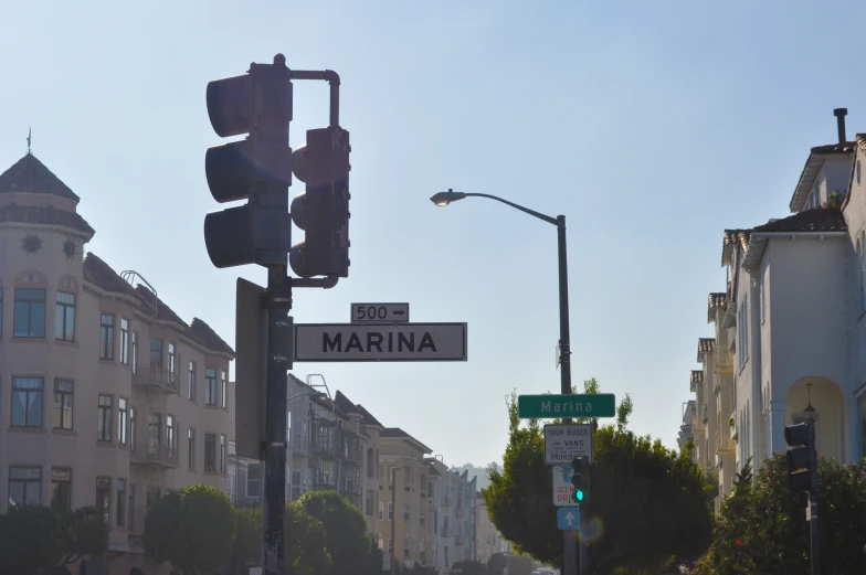 a street sign sits on the corner near tall buildings