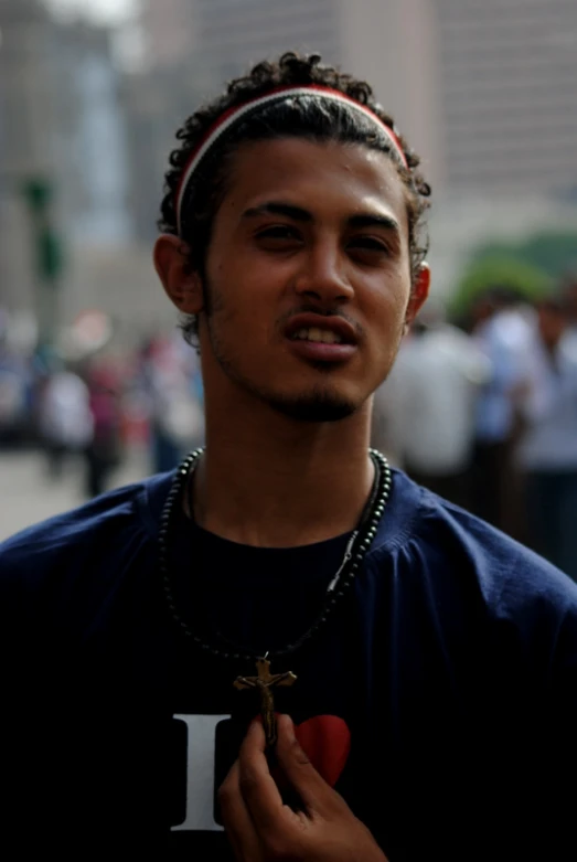 a young man in blue and white wearing a black shirt