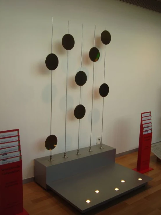 several plates hanging on top of a metal stand