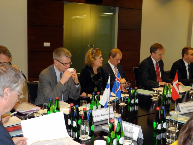 men and women sitting at a meeting table talking