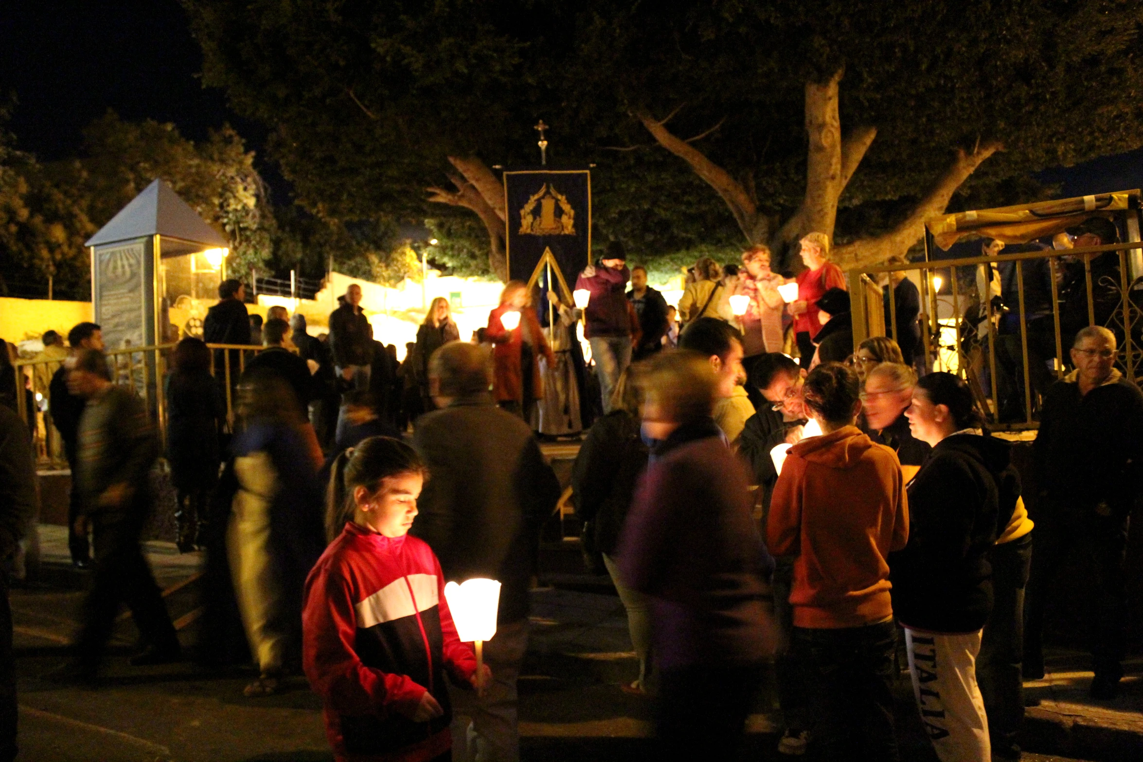 a crowded street with a group of people at night