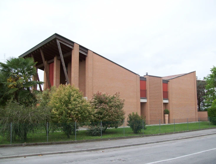 the red brick building is in front of the tall metal structure