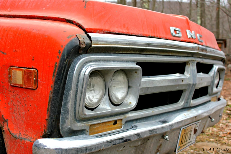 an old and rusty looking truck has the headlights on