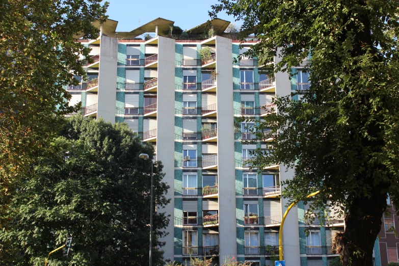 a tall building next to trees in a city