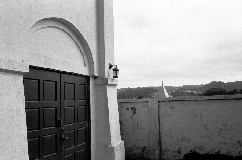 the side of a house with a large door that has a man on the back of it