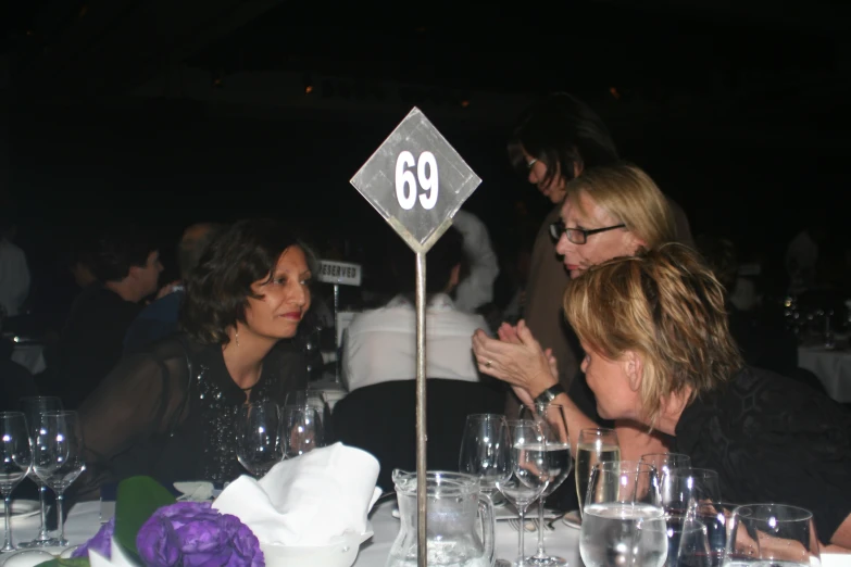 people at a restaurant table sharing a drink