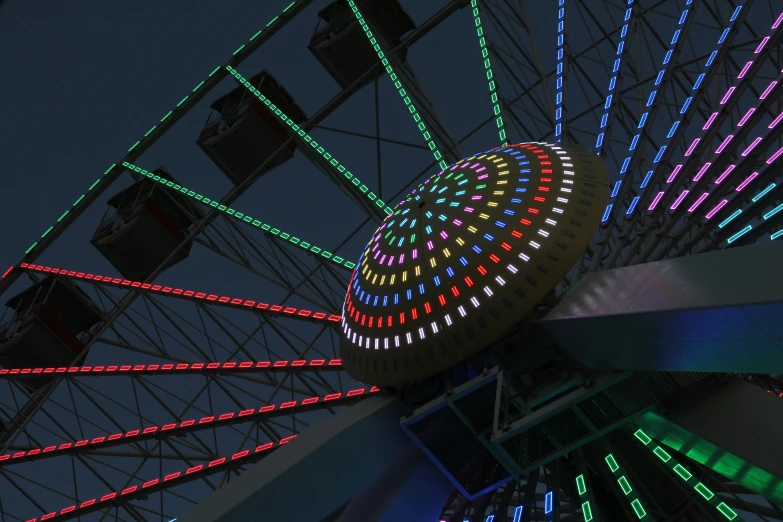 a ferris wheel that is lit up with multicolored lights