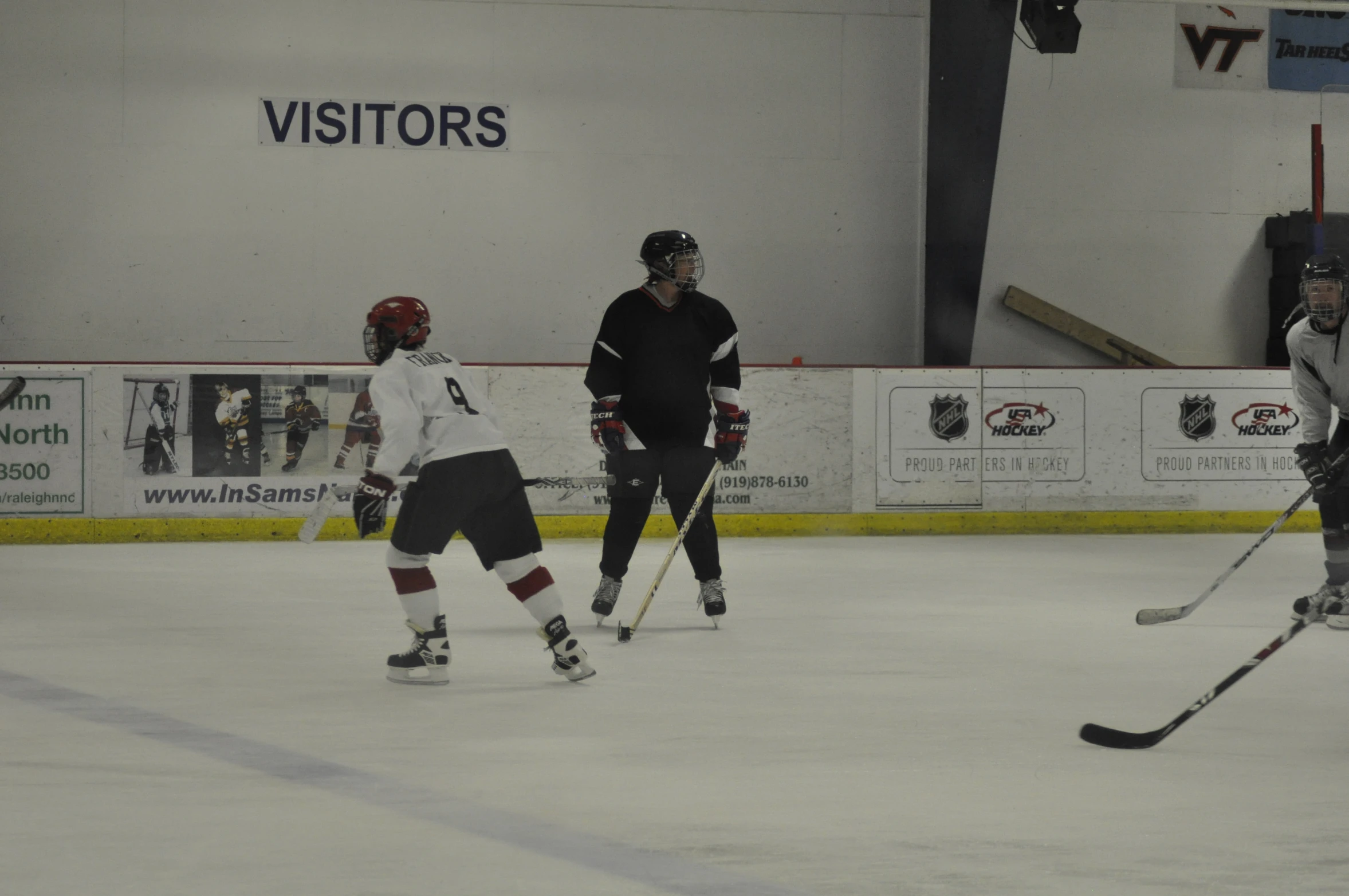 some people are playing hockey on the ice