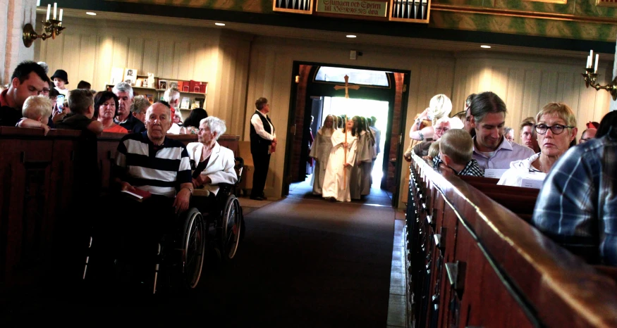 a long hallway with people in wheelchairs on the side of it