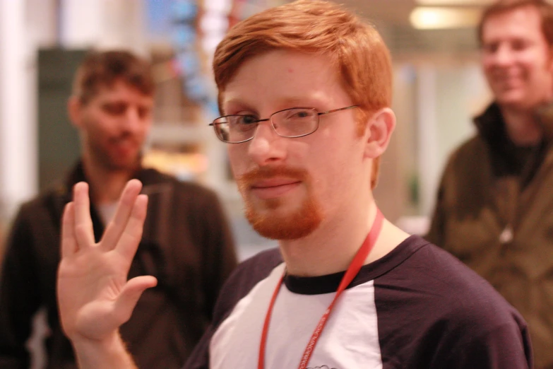 two men with a red beard are standing outside