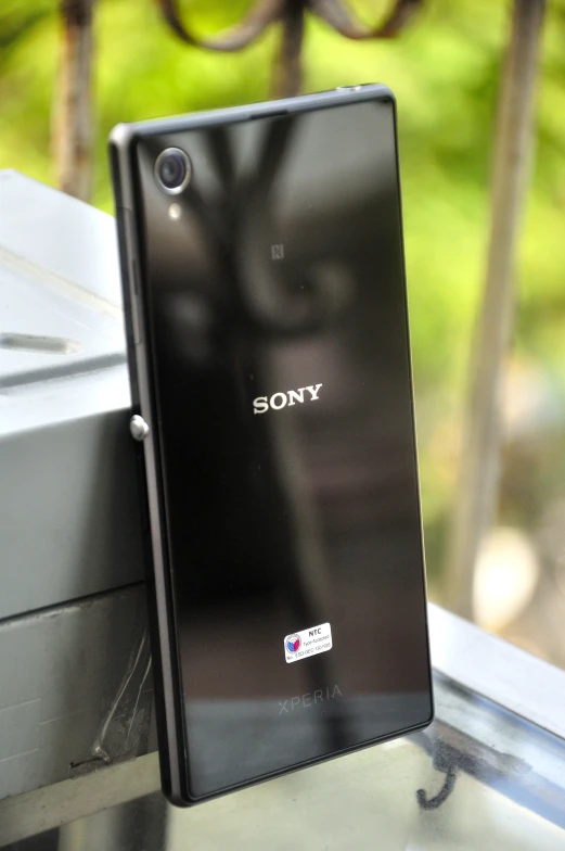 a sony phone sitting next to an enclosure