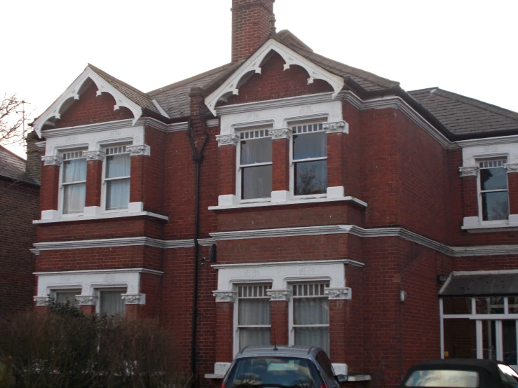 a large brick house with arched windows and white trim