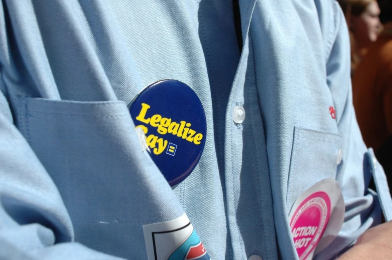 a man in blue shirt with badge on it