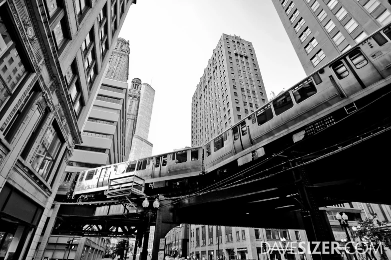 a city scene with high rise buildings and a train