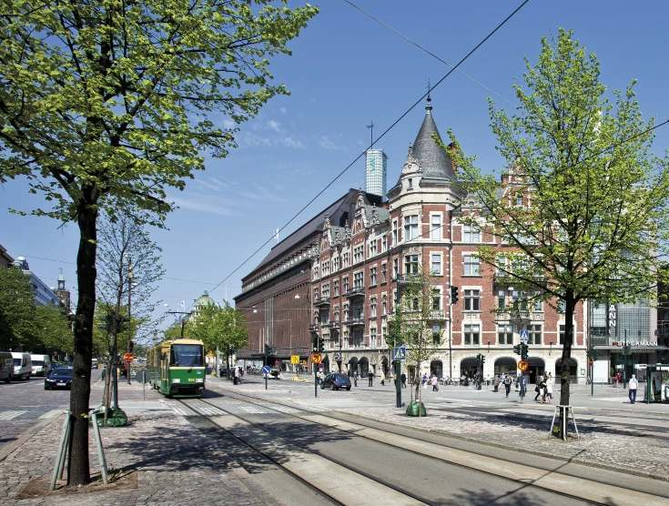 the street scene features a railway track and street lights