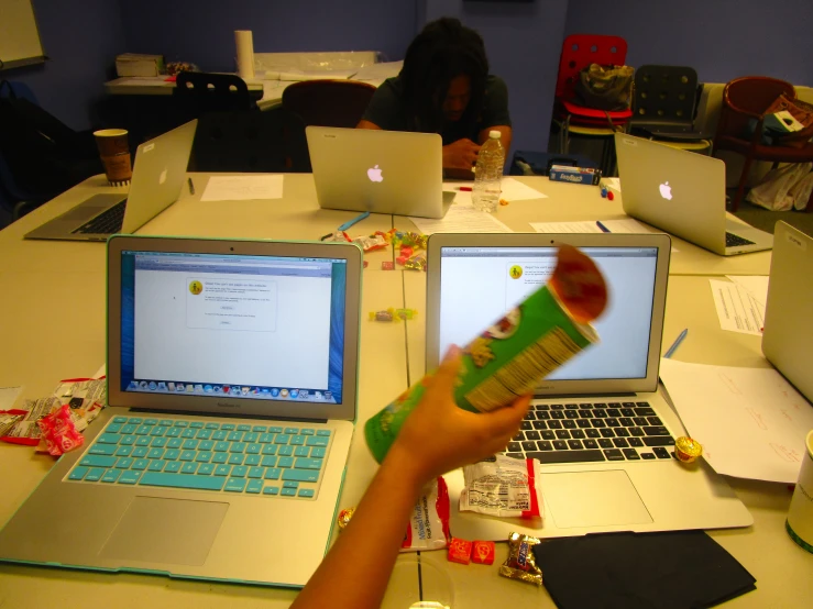 a person is taking part in an activity in front of two laptops