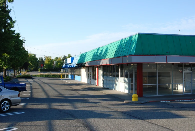 an empty parking lot with a store next to it