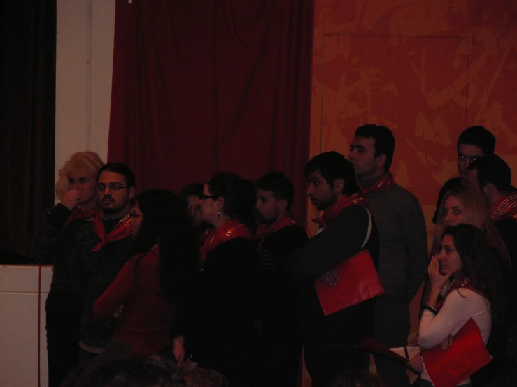 people dressed up with red and black attire standing in line