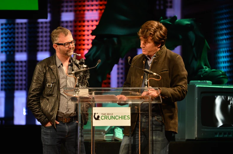 two men on stage at an event