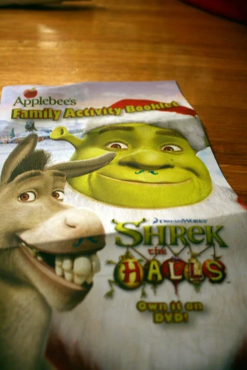a table with two pamphlets on it, one showing shrek the donkey