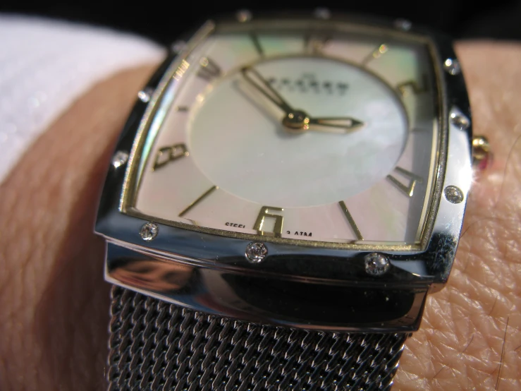 an elegant square watch on a mans wrist