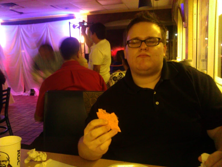 a man eating food while sitting in a restaurant