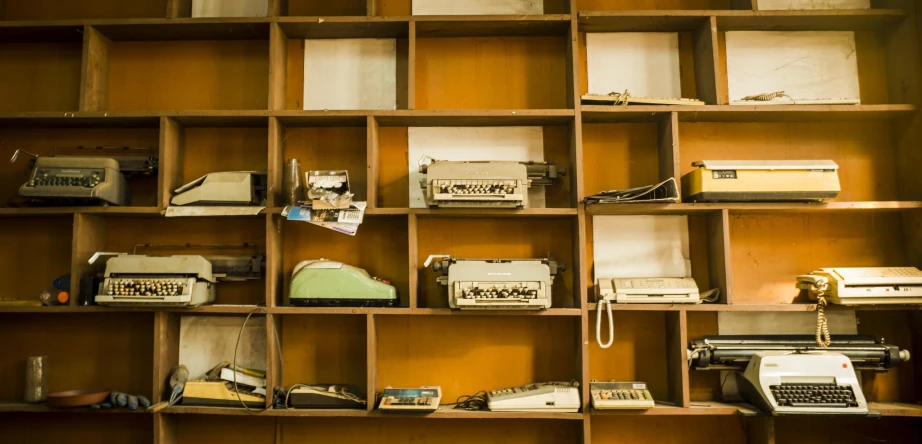 there are many shelves with various old fashioned telephones