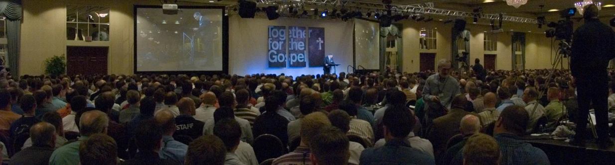 people in an auditorium waiting for a presentation