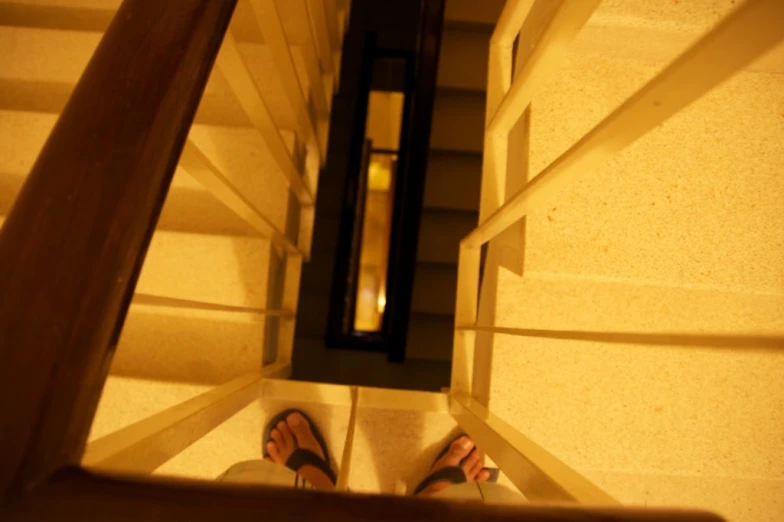 person standing in the bottom part of a stair case