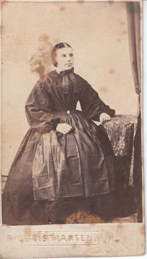 a black - and - white po of a young woman wearing a dress