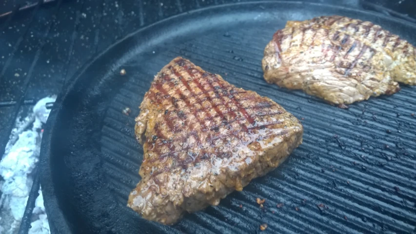 the steak is cooking on the griddle grill