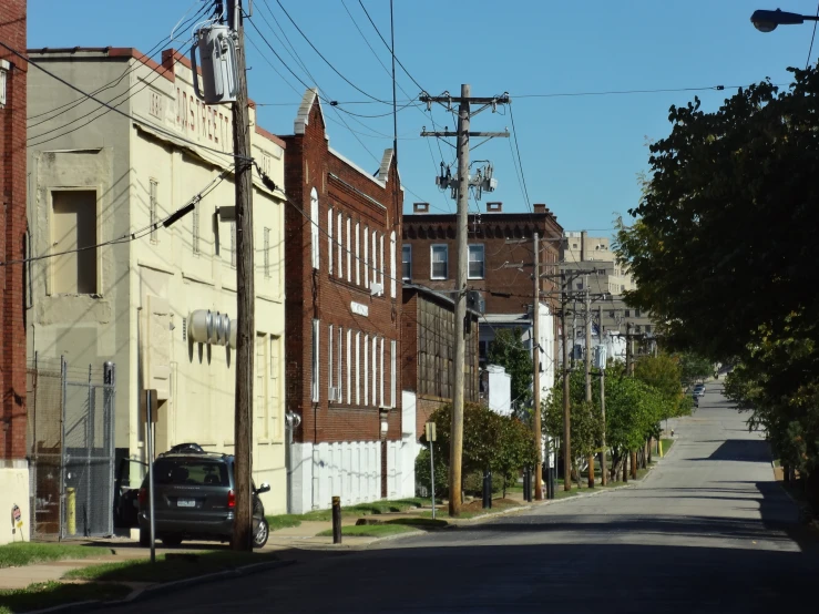 a car is parked on the curb near a residential street