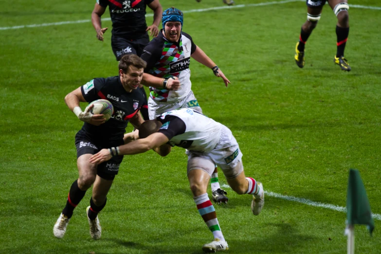 men on the field playing rugby in uniform