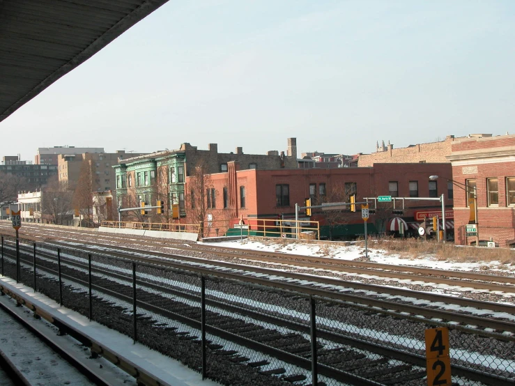buildings, snow and railroad tracks in a small town