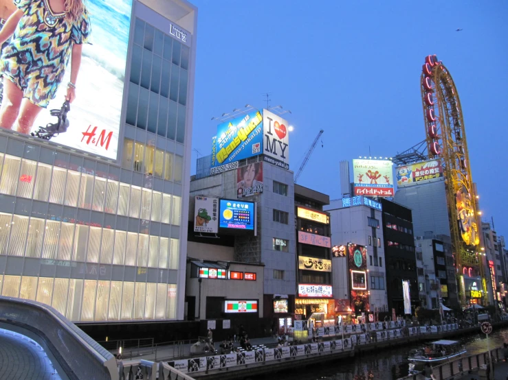 a bunch of tall buildings that have billboards on them